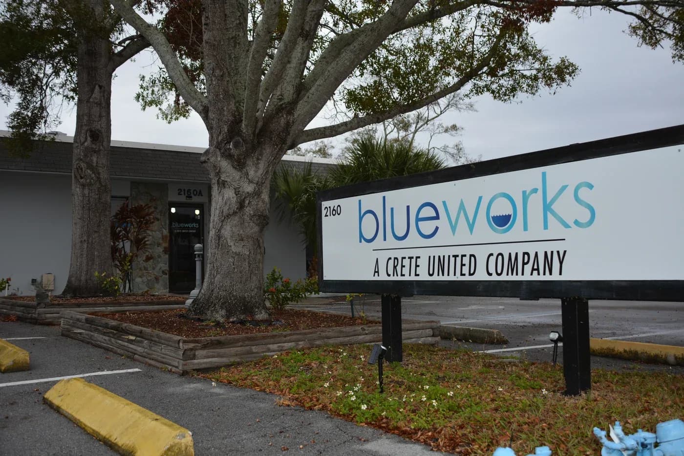 Blue Works Plumbing monument sign at a Florida office.