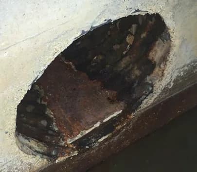 Deteriorated corrugated-metal drain pipe before lining at the FPL facility.